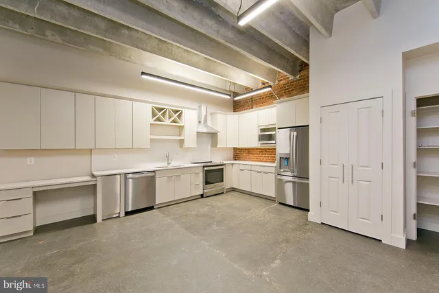 a kitchen with a white cabinets and white appliances