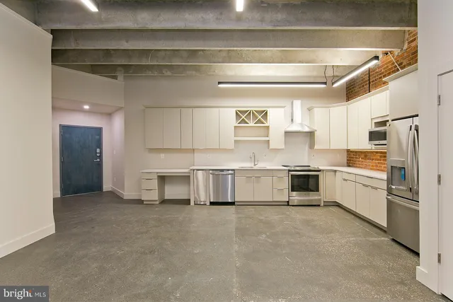 a kitchen with stainless steel appliances and white cabinets