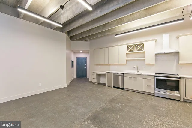 a view of a kitchen with a sink and dishwasher cabinets