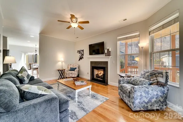 a living room with furniture a fireplace and a flat screen tv