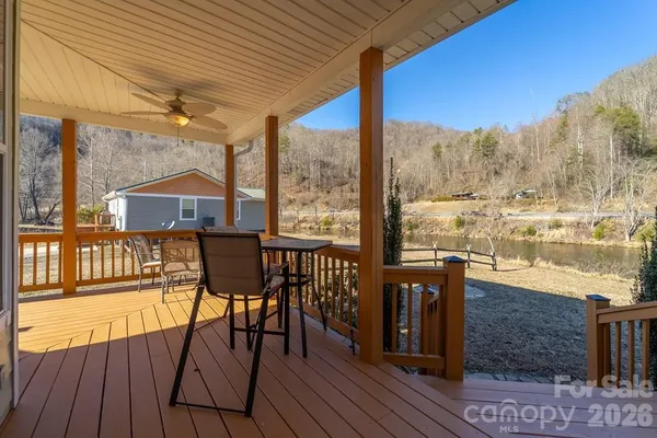 a view of a balcony with chairs and wooden floor