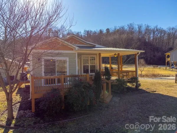 a view of a house with backyard sitting area and garden