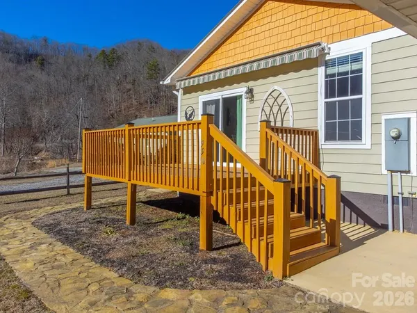 a view of a house with backyard and deck