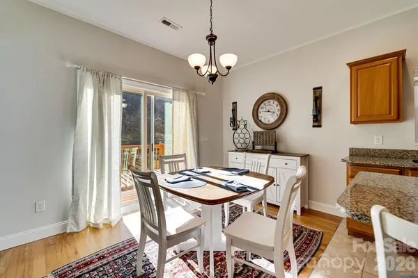 a view of a dining room with furniture wooden floor and a chandelier