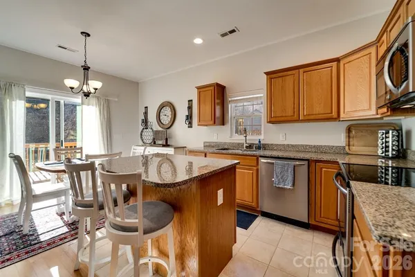 a kitchen with granite countertop a sink and a stove
