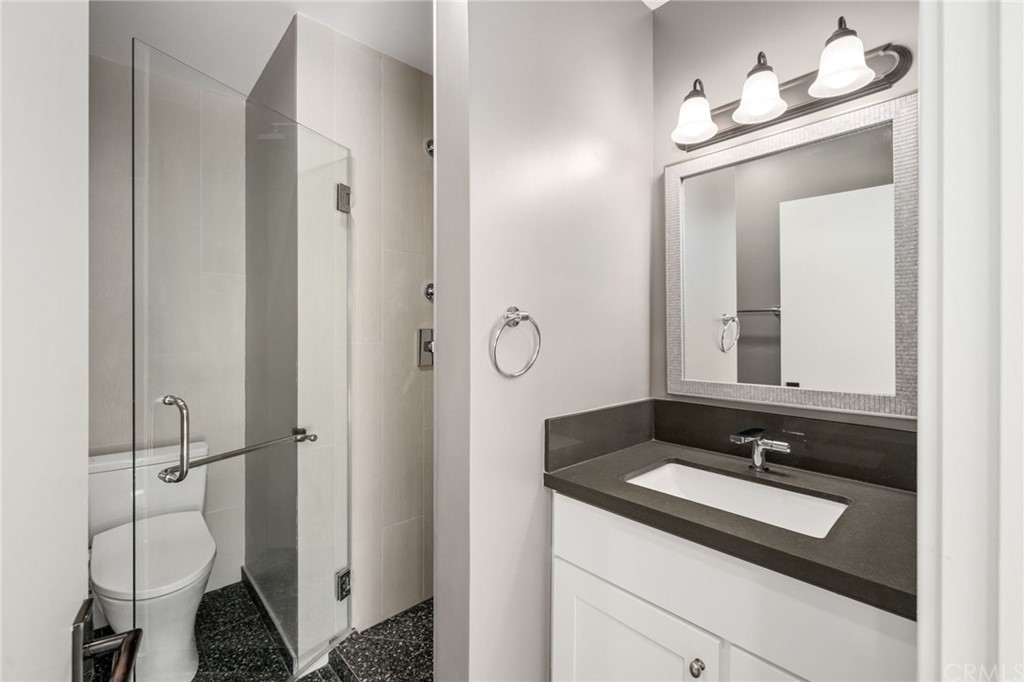 5 Clipper Road, Unit C Rancho Palos Verdes, CA 90275 - Photo 5 of 12 a bathroom with a sink a toilet and a mirror