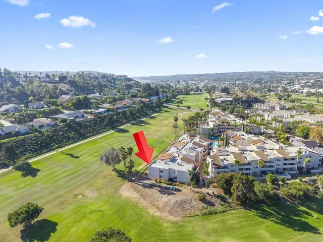 an aerial view of residential houses with outdoor space and swimming pool