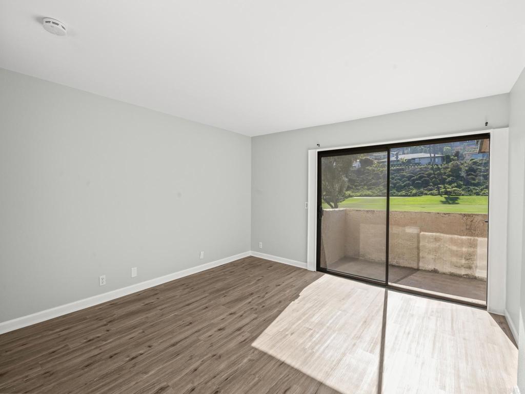 2639 Pirineos Way, Unit 231 Carlsbad, CA 92009 - Photo 12 of 34 a view of a room with wooden floor and sliding door