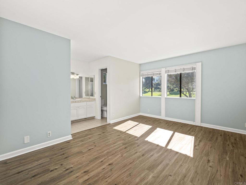2639 Pirineos Way, Unit 231 Carlsbad, CA 92009 - Photo 17 of 34 wooden floor in an empty room with a window