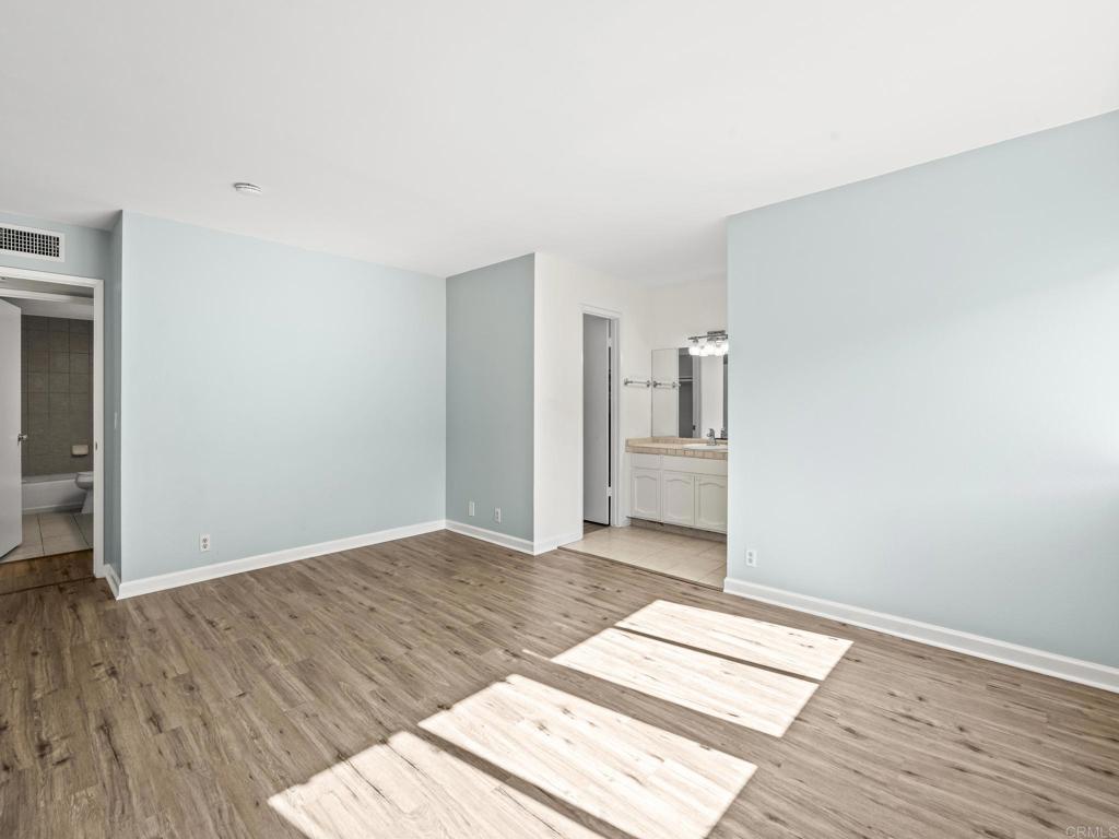 2639 Pirineos Way, Unit 231 Carlsbad, CA 92009 - Photo 18 of 34 a view of a room with wooden floor and windows
