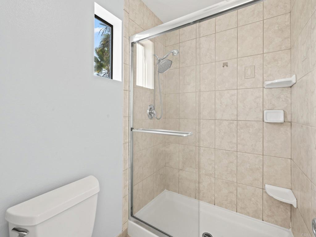 2639 Pirineos Way, Unit 231 Carlsbad, CA 92009 - Photo 20 of 34 a bathroom with a toilet and a shower