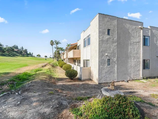 a view of a house with a yard and ocean view