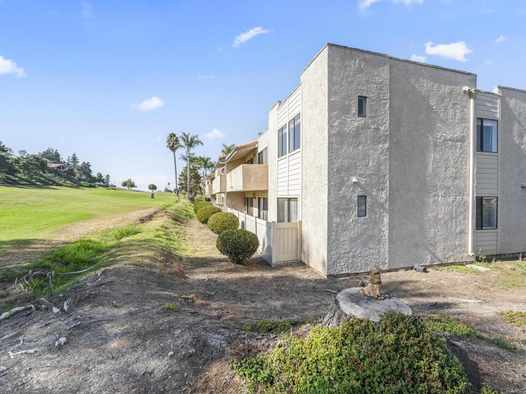 2639 Pirineos Way, Unit 231 Carlsbad, CA 92009 - Photo 27 of 34 a view of a house with a yard and ocean view