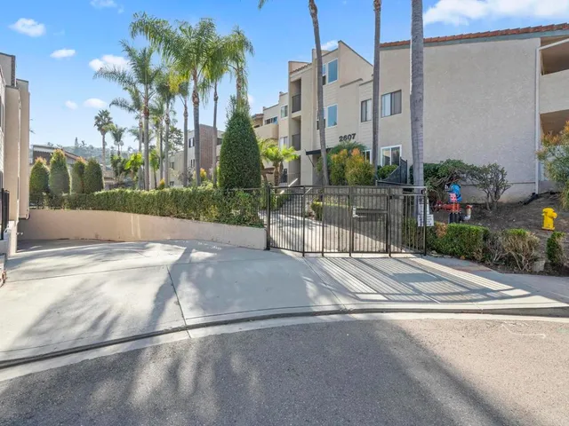 a view of a street with a cars park in front of it