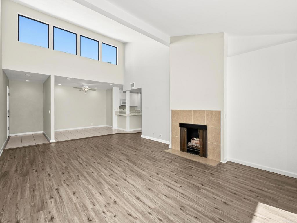 2639 Pirineos Way, Unit 231 Carlsbad, CA 92009 - Photo 4 of 34 a view of a livingroom with wooden floor and a fireplace