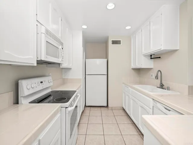 a kitchen with a sink a stove and refrigerator