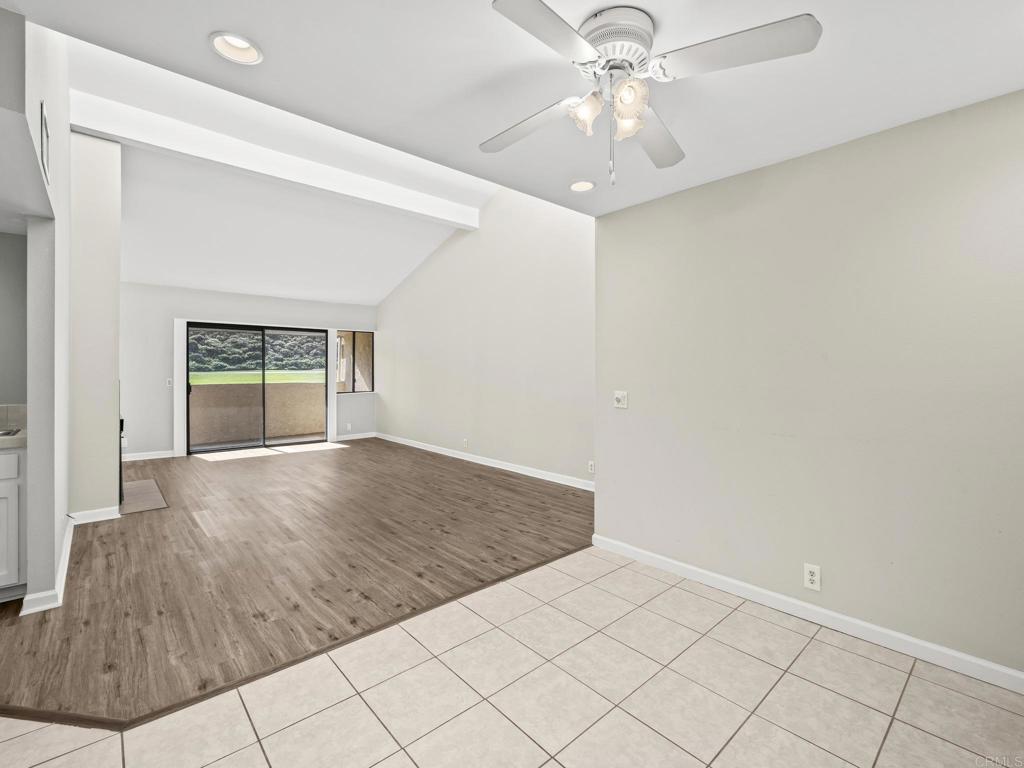 2639 Pirineos Way, Unit 231 Carlsbad, CA 92009 - Photo 9 of 34 an empty room with chandelier fan and windows