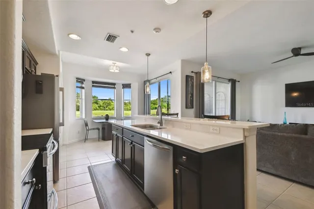 a kitchen with stainless steel appliances granite countertop a sink a stove and a refrigerator