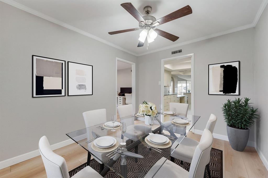 Updated flooring, the dining room is adjacent to the kitchen and bonus room. Staged photo. 
