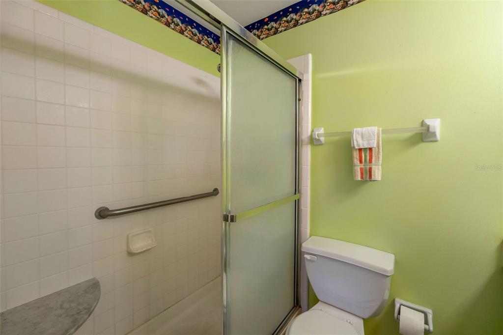 1814 Fox Hunt Drive, Unit A Sun City Center, FL 33573 - Photo 12 of 23 a bathroom with a toilet and a shower