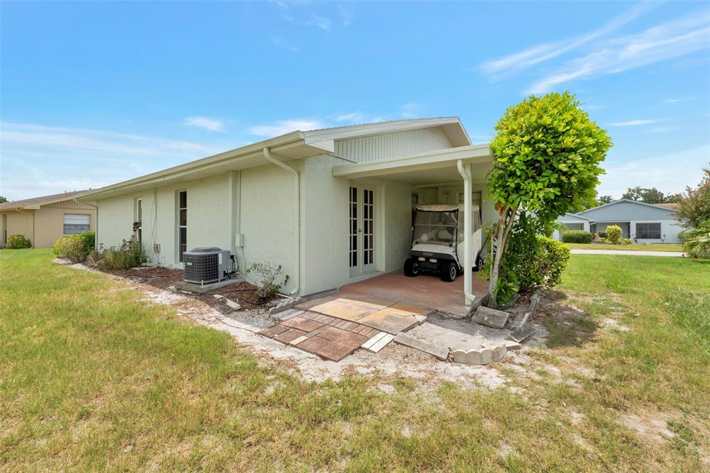 1814 Fox Hunt Drive, Unit A Sun City Center, FL 33573 - Photo 13 of 23 a view of a house with backyard and a tree