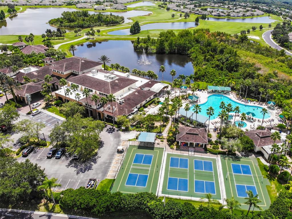 1814 Fox Hunt Drive, Unit A Sun City Center, FL 33573 - Photo 22 of 23 an aerial view of a house with a garden and lake view