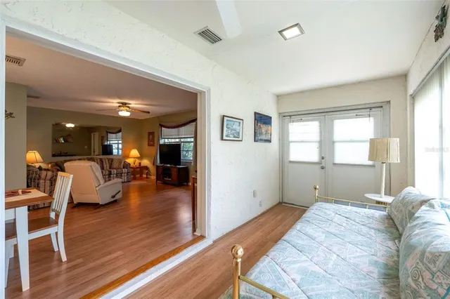 a bedroom with furniture and a wooden floor