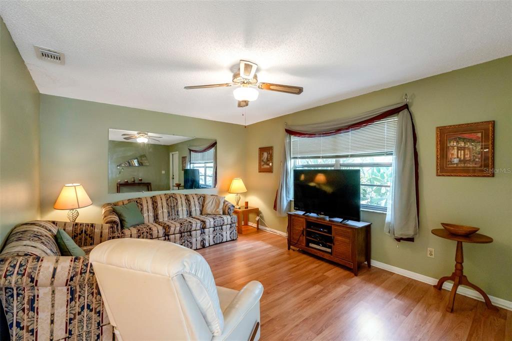 1814 Fox Hunt Drive, Unit A Sun City Center, FL 33573 - Photo 5 of 23 a living room with furniture and a flat screen tv