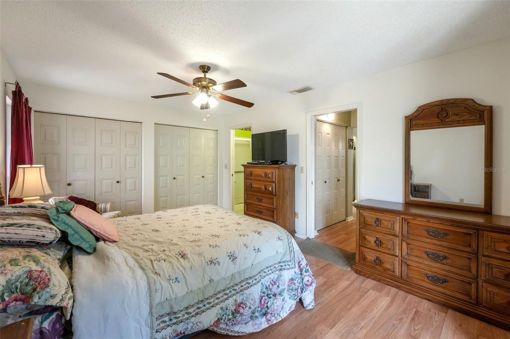 1814 Fox Hunt Drive, Unit A Sun City Center, FL 33573 - Photo 10 of 23 a spacious bedroom with a bed and a flat screen television