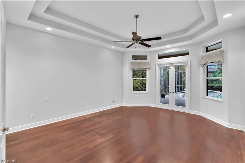 6676 Glen Arbor Way Naples, FL 34119 - Photo 14 of 23 a view of an empty room with window and wooden floor