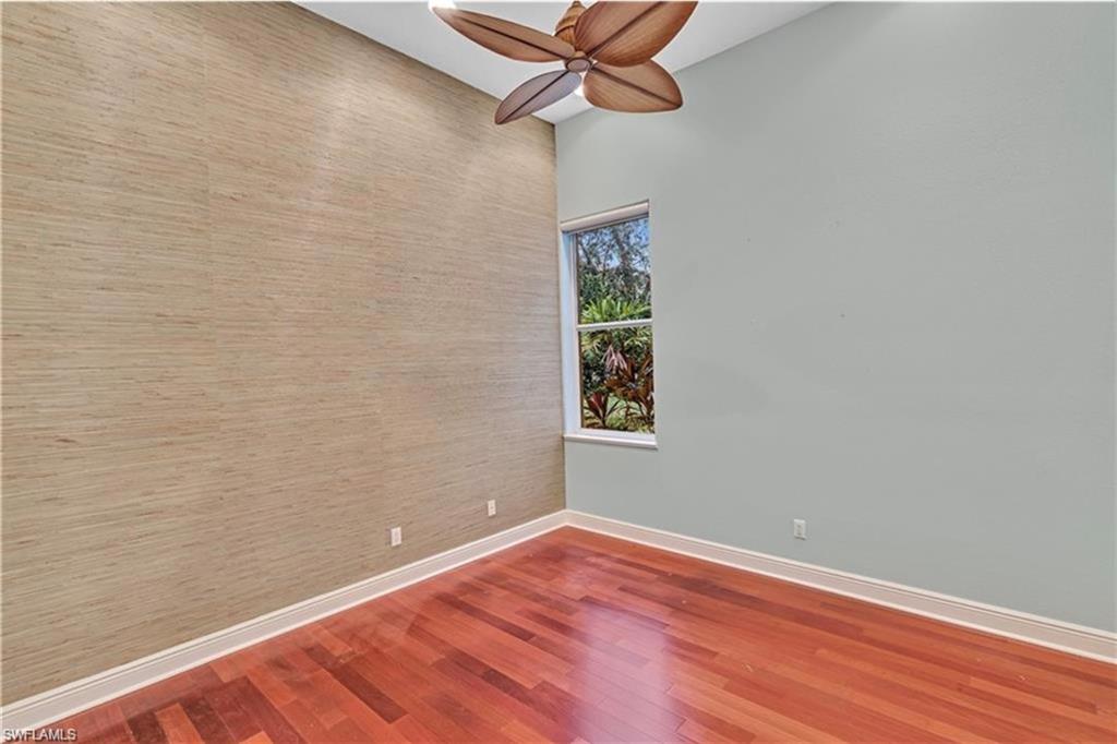 6676 Glen Arbor Way Naples, FL 34119 - Photo 17 of 23 a view of a room with wooden floor and fan
