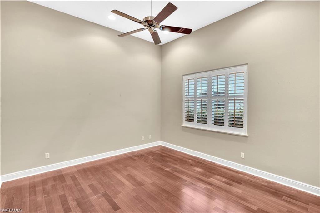 6676 Glen Arbor Way Naples, FL 34119 - Photo 19 of 23 an empty room with a window and a fan