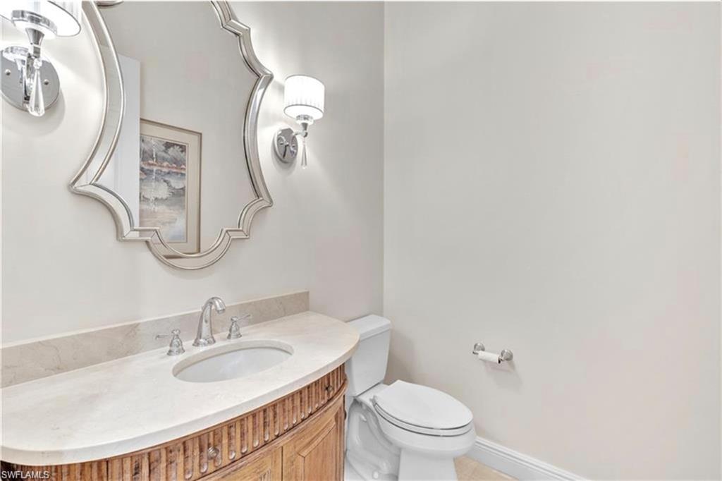 6676 Glen Arbor Way Naples, FL 34119 - Photo 20 of 23 a bathroom with a sink and a mirror