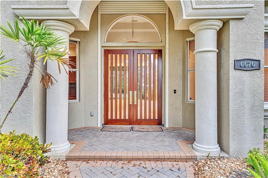 6676 Glen Arbor Way Naples, FL 34119 - Photo 2 of 23 a view of a entryway door of the house