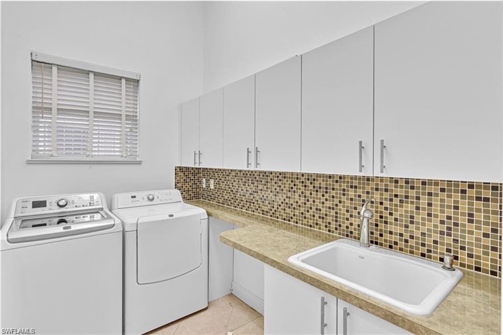 6676 Glen Arbor Way Naples, FL 34119 - Photo 21 of 23 a utility room with dryer and washer
