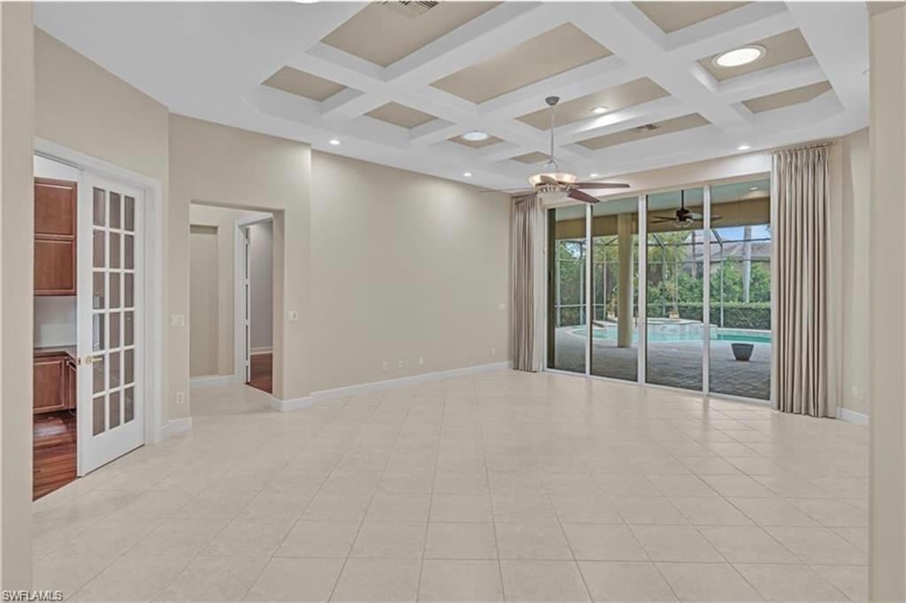 6676 Glen Arbor Way Naples, FL 34119 - Photo 5 of 23 a view of an empty room with a sliding door