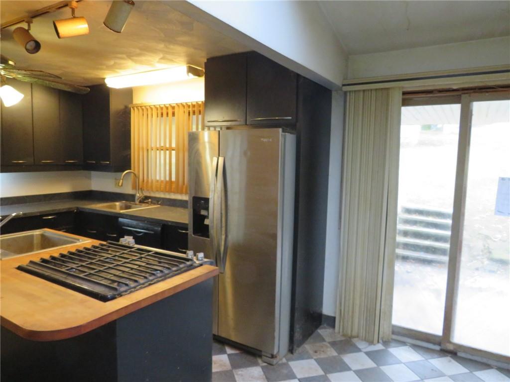 11175 Old Trail Road Irwin, PA 15642 - Photo 23 of 48 a kitchen with stainless steel appliances granite countertop a refrigerator and a sink