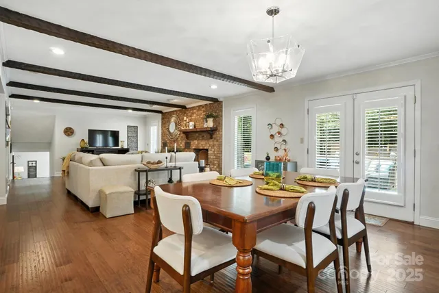 a view of a dining room with furniture wooden floor and chandelier