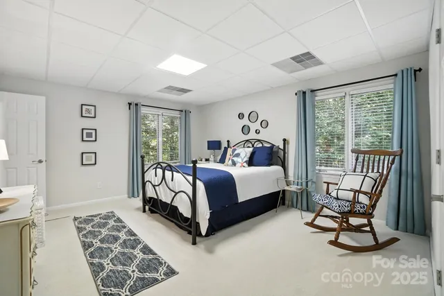 a bed sitting in a bedroom next to a window