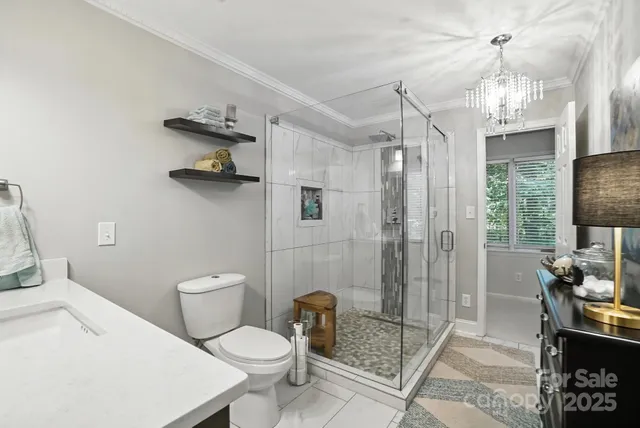 a bathroom with a toilet a sink and shower