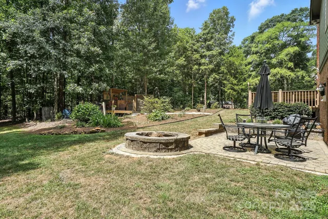 a view of a backyard with sitting area