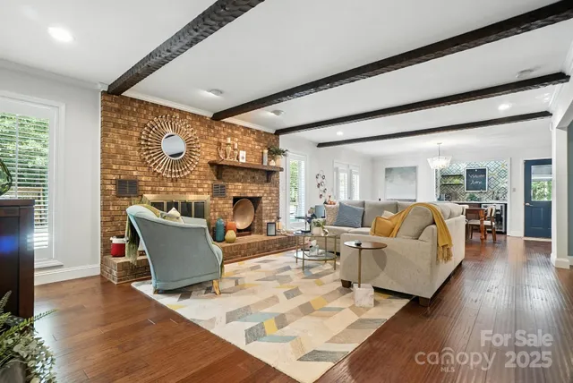 a living room with furniture a fireplace and a flat screen tv