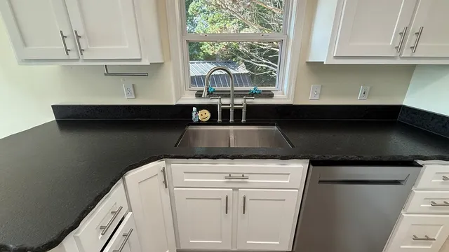 a spacious bedroom with a large bed and a chandelier