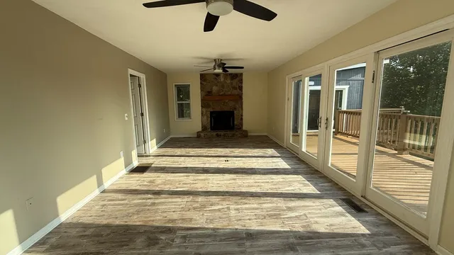 a view of a porch with furniture and wooden floor