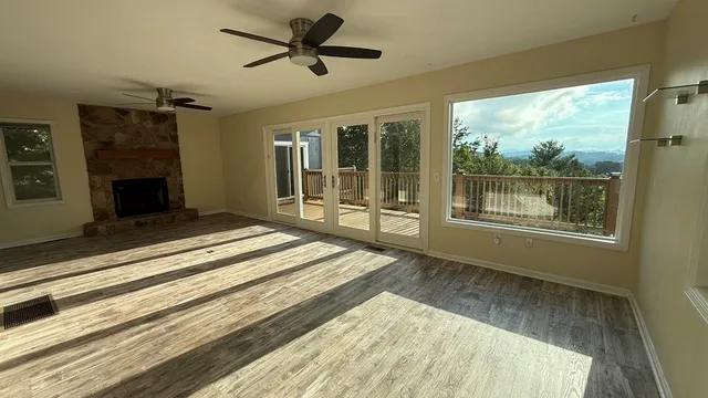 a view of a porch with chairs and backyard of the house