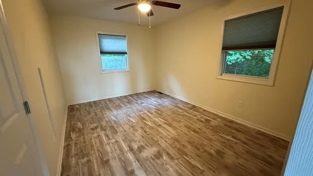 a front view of a house with a yard and balcony