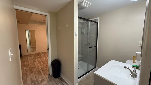 a view of hallway with wooden floor and closet