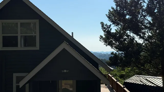 a view of empty room with window and wooden floor