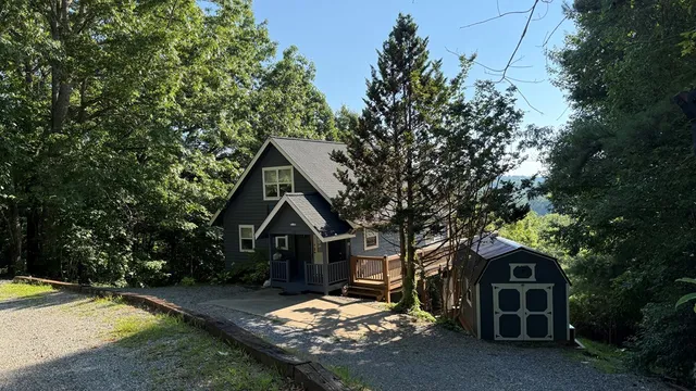 a living room with hardwood floor and a large window