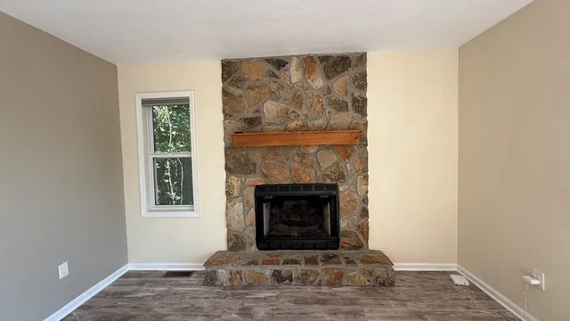 a view of a room with wooden floor and windows